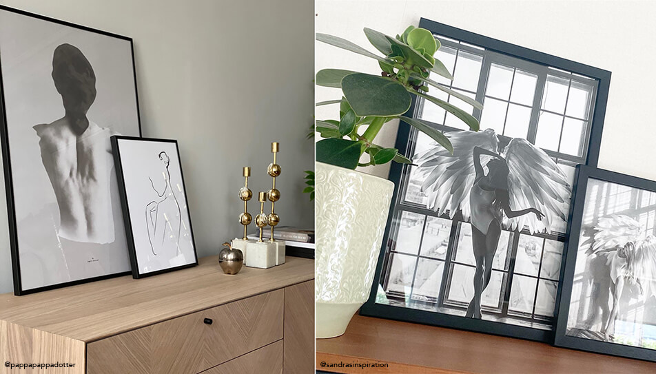 Quadri in bianco e nero appoggiati su una credenza