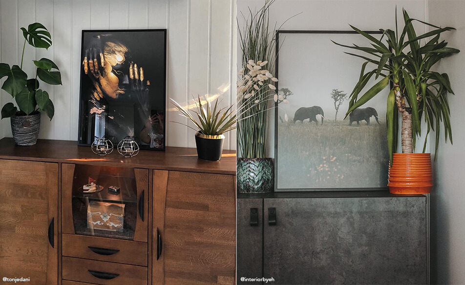 Quadri e piante posizionati su una credenza